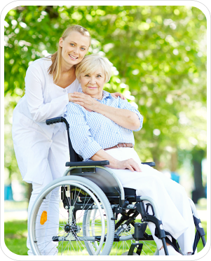 Pretty nurse taking care of senior patient in a wheelchair